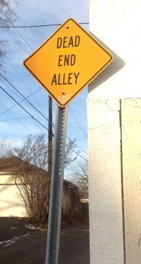 dead end sign at entry to alley