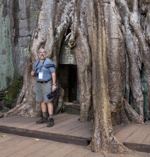 Mark standing in root-enclosed doorway