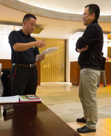 Hung and Truong standing, talking