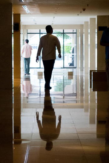 silhouette of man standing in hall