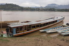 one larger long narrow boat, several sampans