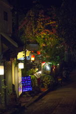 brightly-lit shop on dark street
