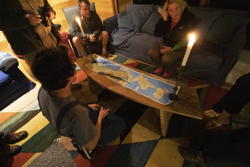Nick and a map of the peninsula, under candle light