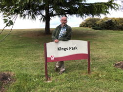 Mark, standing behind sign saying “Kings Park”