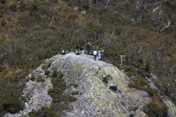 people standing on a peak